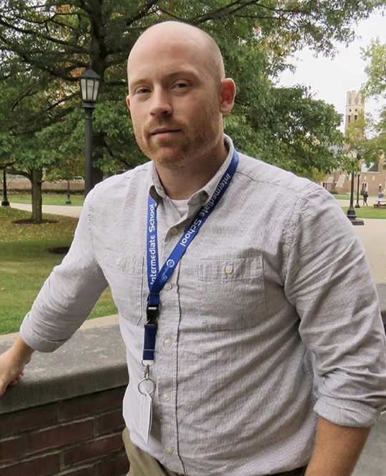 Man with shaved head and facial hair