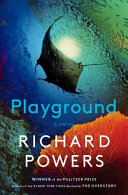 Underwater image of a manta ray from below amongst coral & a school of tiny fish, with title and author text.