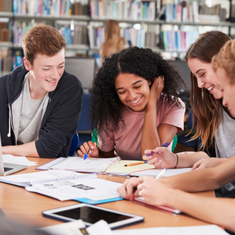 Group of young adults working together at a table