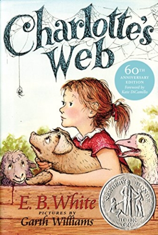 Little girl holding a young pig looking at a spider.