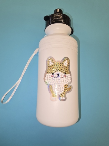 Water bottle with diamond art sticker on front of a dog
