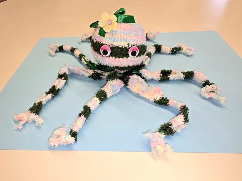 Cute octopus made out of a green and white striped sock
