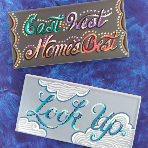 Painted tiles that say "East West Home's Best" and "Look Up" in script