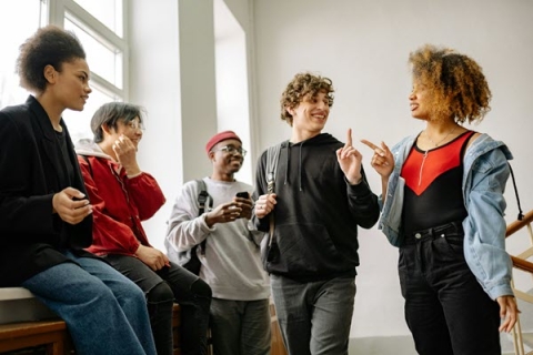 group of teens laughing and talking