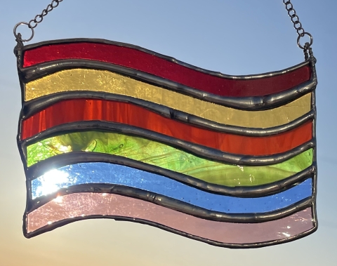 a rainbow striped stained glass flag