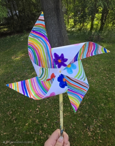 a colorful, paper pinwheel on a pencil