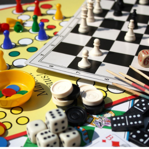 assorted board games and pieces for checkers, chess, dice