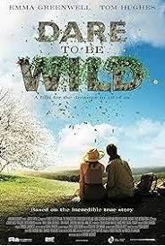 2 back turned figures (a man & woman) look out to a wild landscape. The film's title is compsed of letters that are turning into vegetation.