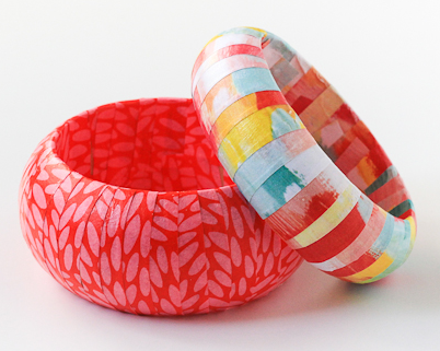 Two brightly colored and patterned bangle bracelets - one almost fusia in color with a small oval pattern and the other has multi colored stripes