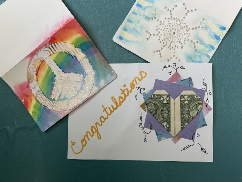 greeting cards and money folded into a heart