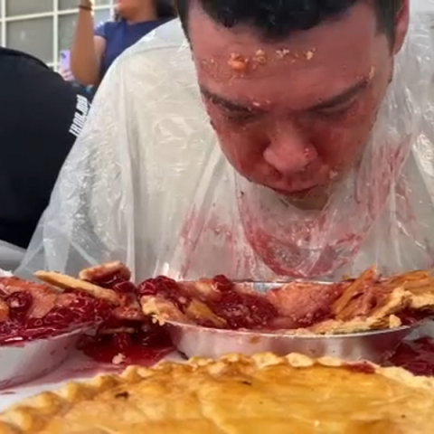 teen boy eating pie with no hands