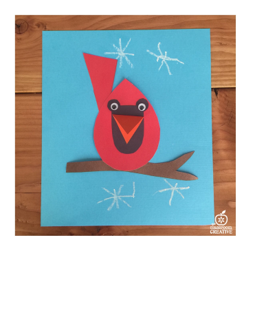 Red Construction paper Cardinal sitting on a branch on a blue background