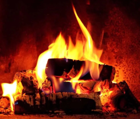 close-up image of a lit Yule log fireplace