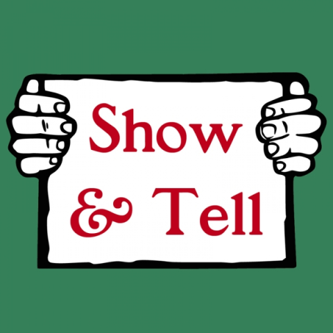Sign with the words, "Show & Tell" in red lettering. Two white hands holding them up. Green background