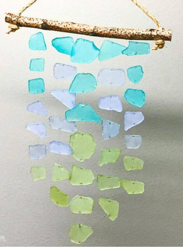 A stick with five strands of colored sea glass hanging from it