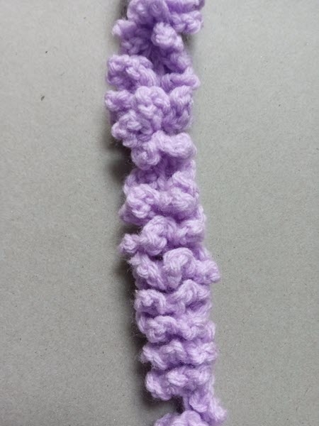 purple yarn crocheted into wisteria flower vine
