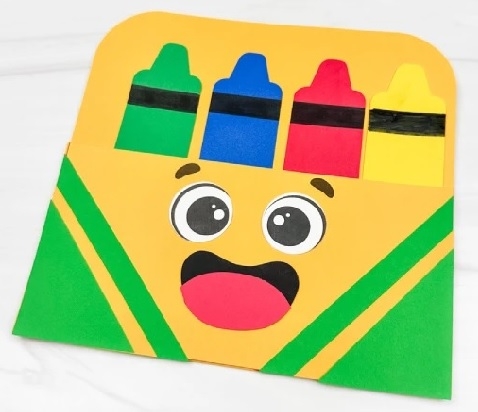 smiling crayon box containing 4 crayons made of colored paper
