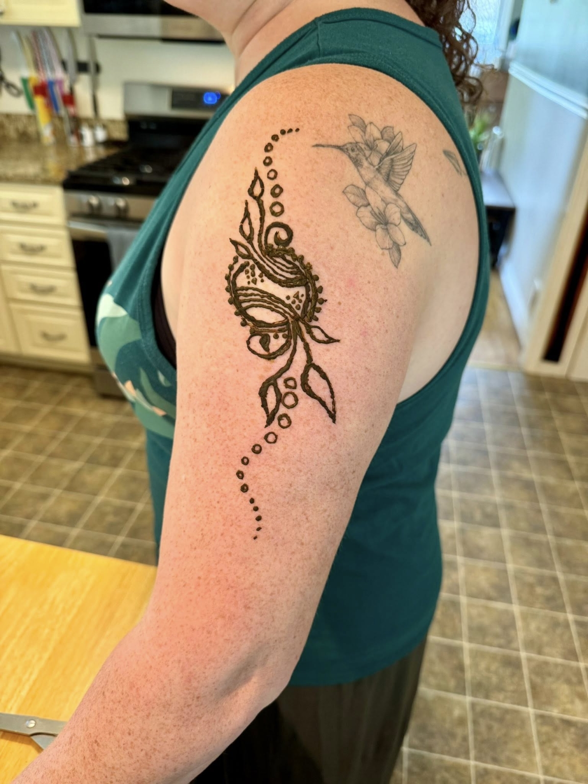 Henna tattoo on a left upper arm.