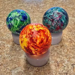 Ping Pong balls painted various colors and placed on tea lights.